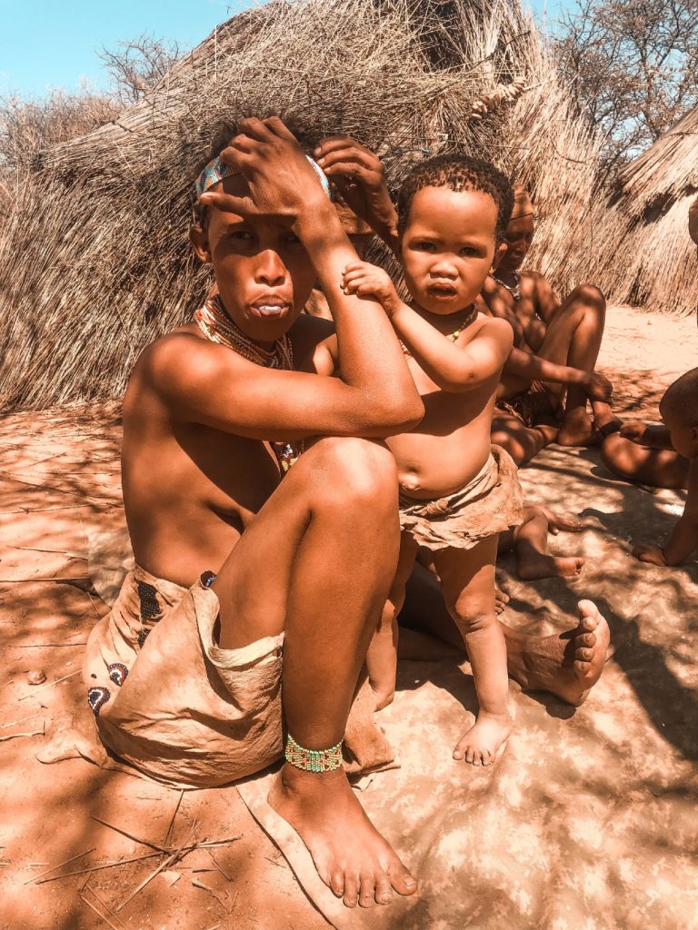 An image of a Kung! bushwoman with her child